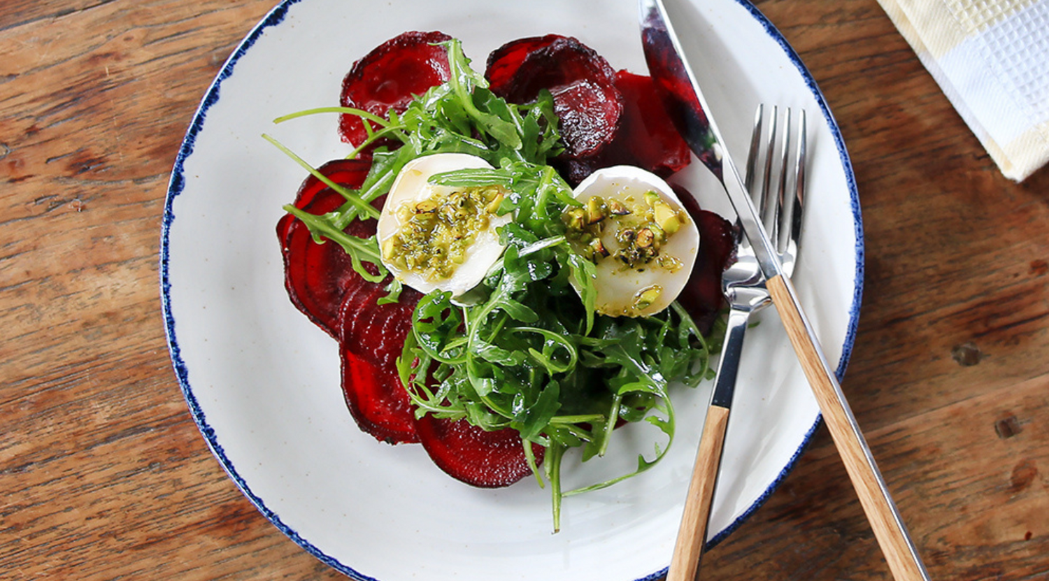 Goat Cheese with a Pistachio and Honey Crust on Red Beet Carpaccio with Arugula